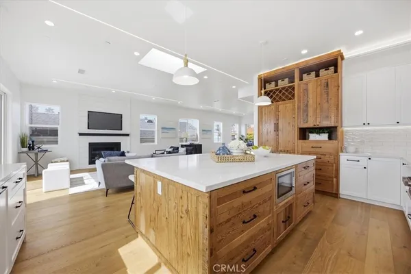 a kitchen with a stove cabinets and wooden floor