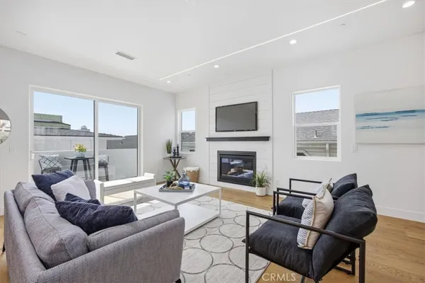 a living room with furniture fireplace and a flat screen tv