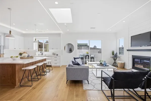 a living room with fireplace furniture and a wooden floor