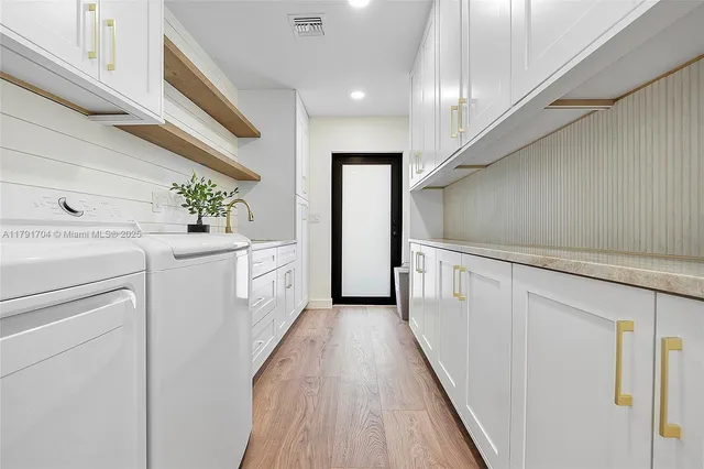 a view of a hallway with washer and dryer