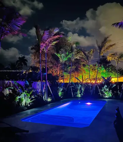 a view of an outdoor space pool patio fire pit and outdoor seating