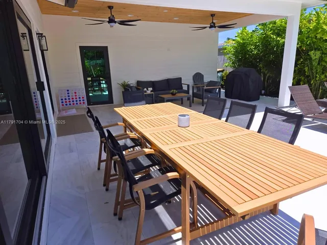a outdoor dining space with furniture and wooden floor