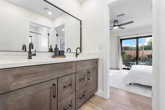 a spacious bathroom with double sink and a mirror