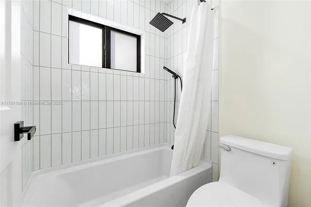 a bathroom with a toilet and a bathtub