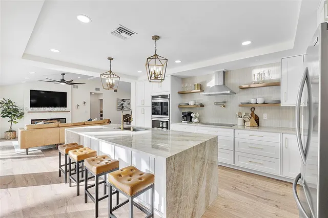 a kitchen with stainless steel appliances kitchen island granite countertop a sink and cabinets