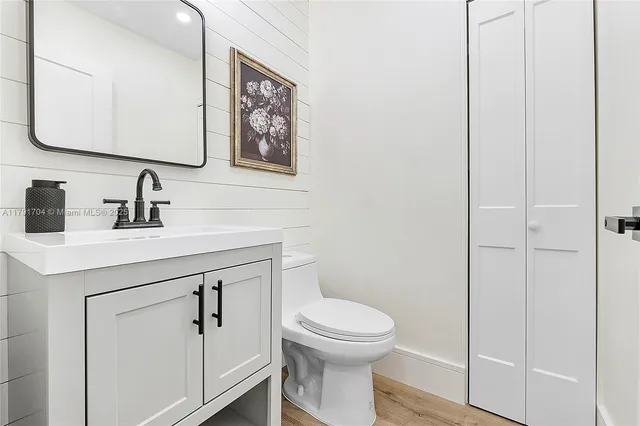 a bathroom with a toilet sink and mirror