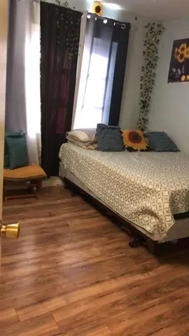 a bedroom with furniture and flat screen tv