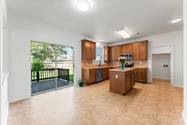 a kitchen with a refrigerator and a sink