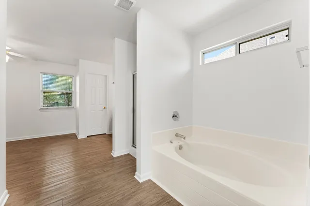 a bathroom with a bathtub and shower