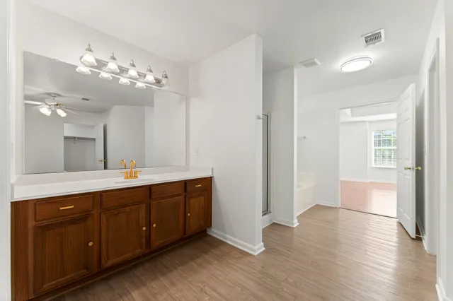 a spacious bathroom with a double vanity sink and a mirror