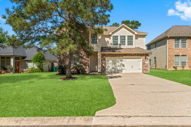 a front view of a house with a yard and garage