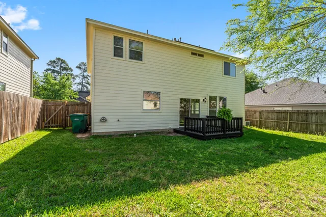 a view of backyard with house and outdoor seating