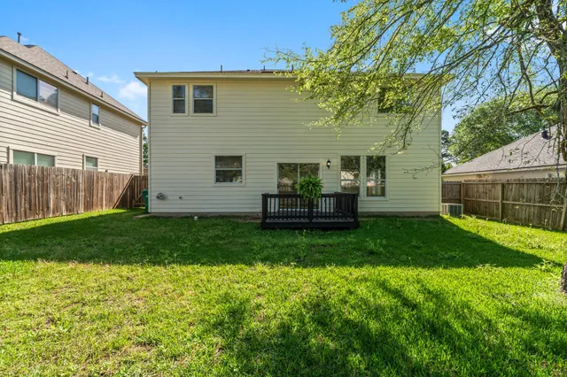 a backyard of a house with table and chairs