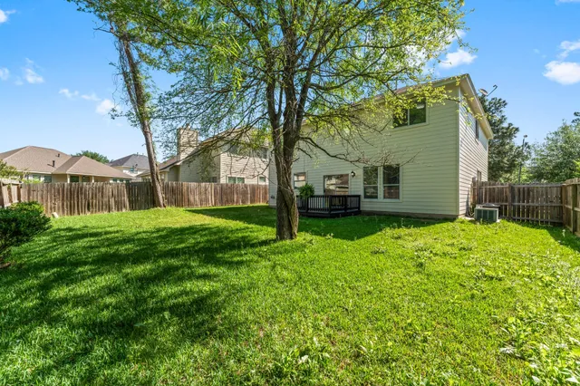 a view of a house with yard and tree s