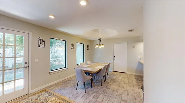 a view of a room with a table and chairs