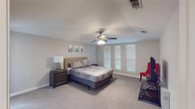 a living room with a bed furniture and a chandelier