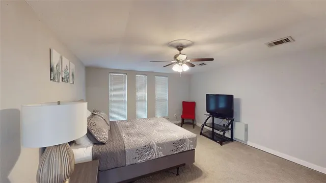 a bedroom with a bed gym equipment and a window