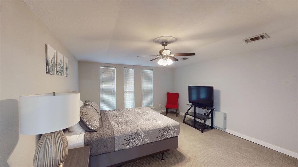 411 Sycamore Creek Road Allen, TX 75002 - Photo 15 of 36 a bedroom with a bed gym equipment and a window