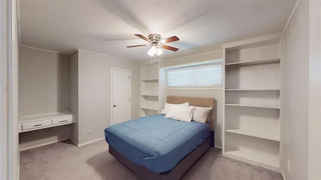 a bedroom with a bed and a ceiling fan