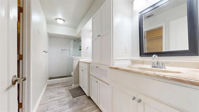 a spacious bathroom with a double vanity sink and mirror
