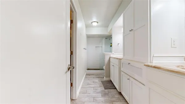 a view of walk in closet with empty racks
