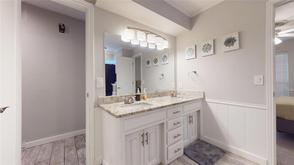 411 Sycamore Creek Road Allen, TX 75002 - Photo 26 of 36 a bathroom with a granite countertop sink and a mirror