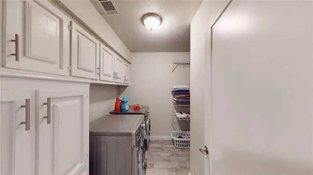 a view of a livingroom with a piano and a chandelier