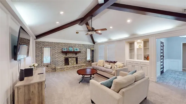 a living room with fireplace furniture and a flat screen tv