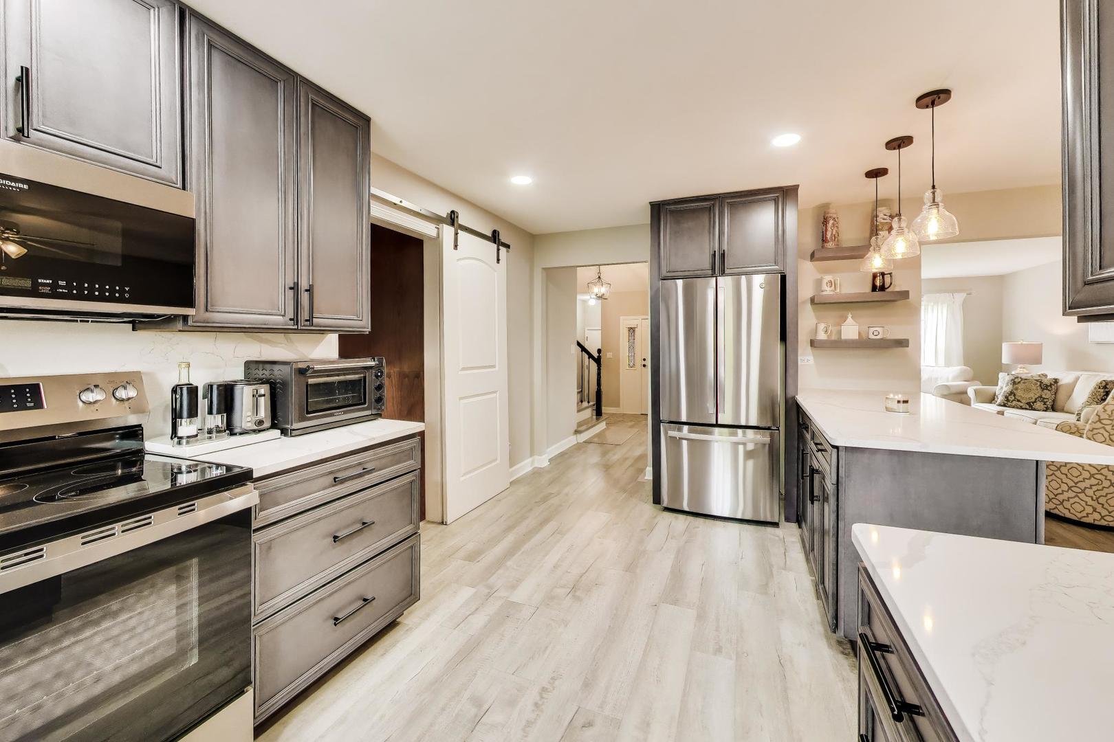 313 South Hi Lusi Avenue Mount Prospect, IL 60056 - Photo 12 of 40 a kitchen with stainless steel appliances a refrigerator stove microwave and cabinets