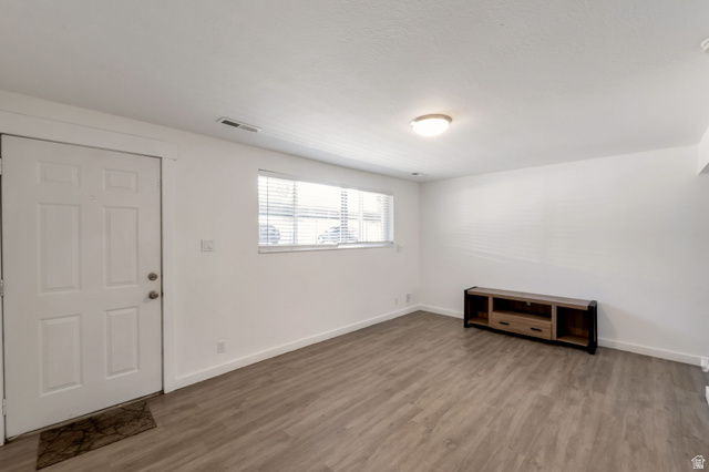 434 South 700 West, Unit 2 Provo, UT 84601 - Photo 3 of 15 Spacious living area featuring wood-finish flooring, white baseboards, and a neutral color palette