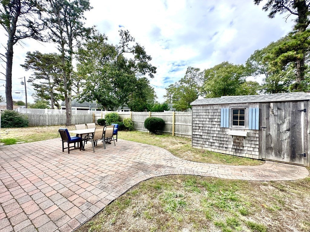 101 Swan River Road Dennis, MA 02670 - Photo 6 of 19 a view of a house with a patio
