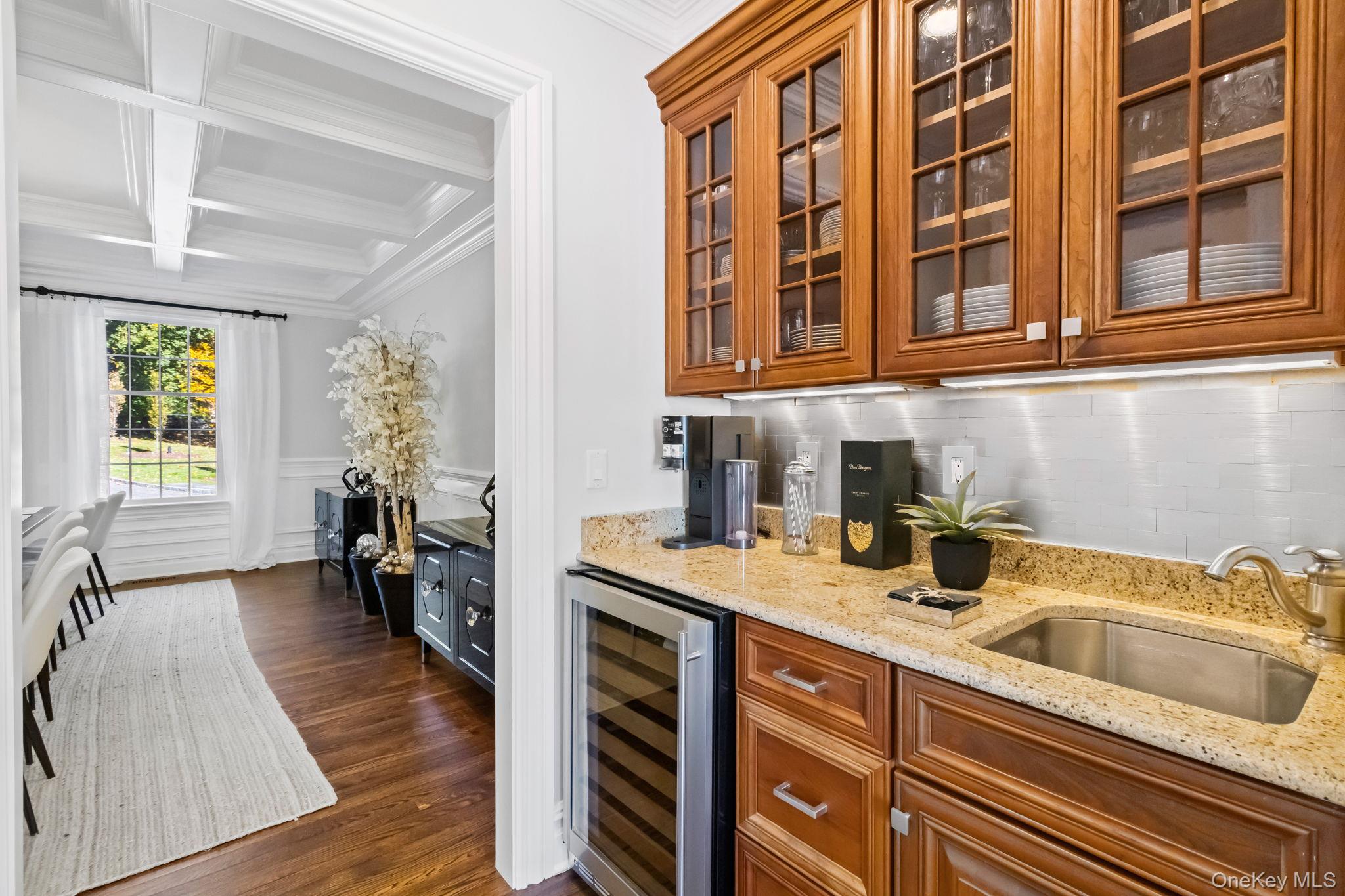 496 Long Ridge Road Bedford, NY 10576 - Photo 11 of 49 Bar area featuring light stone countertops, coffered ceiling, beverage cooler, beam ceiling, and ornamental molding