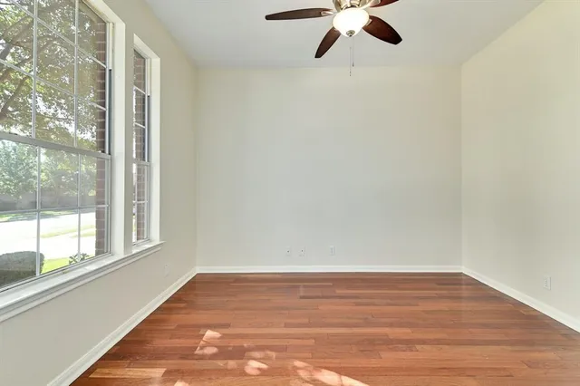 a bathroom with a granite countertop toilet sink and mirror