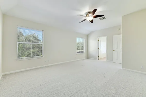 a spacious bathroom with a mirror sink and shower