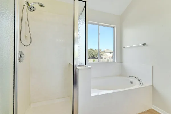 a bathroom with a double vanity sink mirror and shower