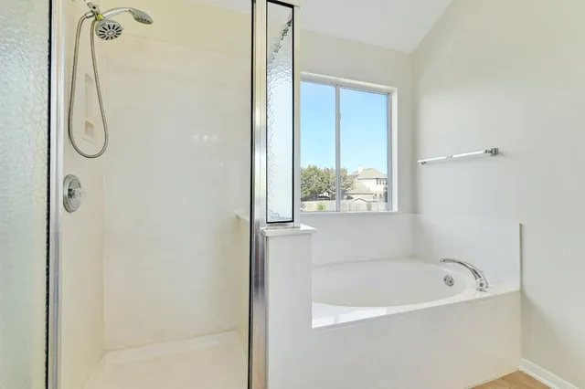 a bathroom with a double vanity sink mirror and shower