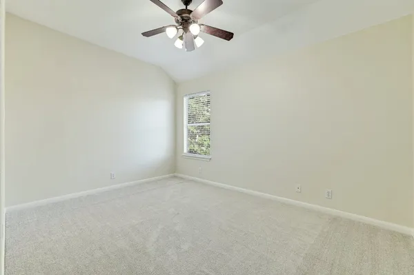 a view of a room with a window and a ceiling fan