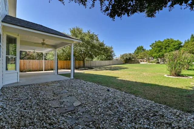 a front view of a house with a garden and plants