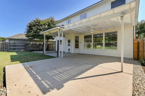 a view of backyard of house with green space