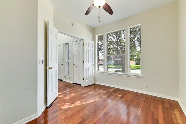 a view of livingroom with hardwood floor and ceiling fan