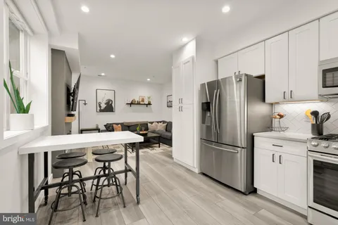 a kitchen with stainless steel appliances a refrigerator stove microwave and cabinets