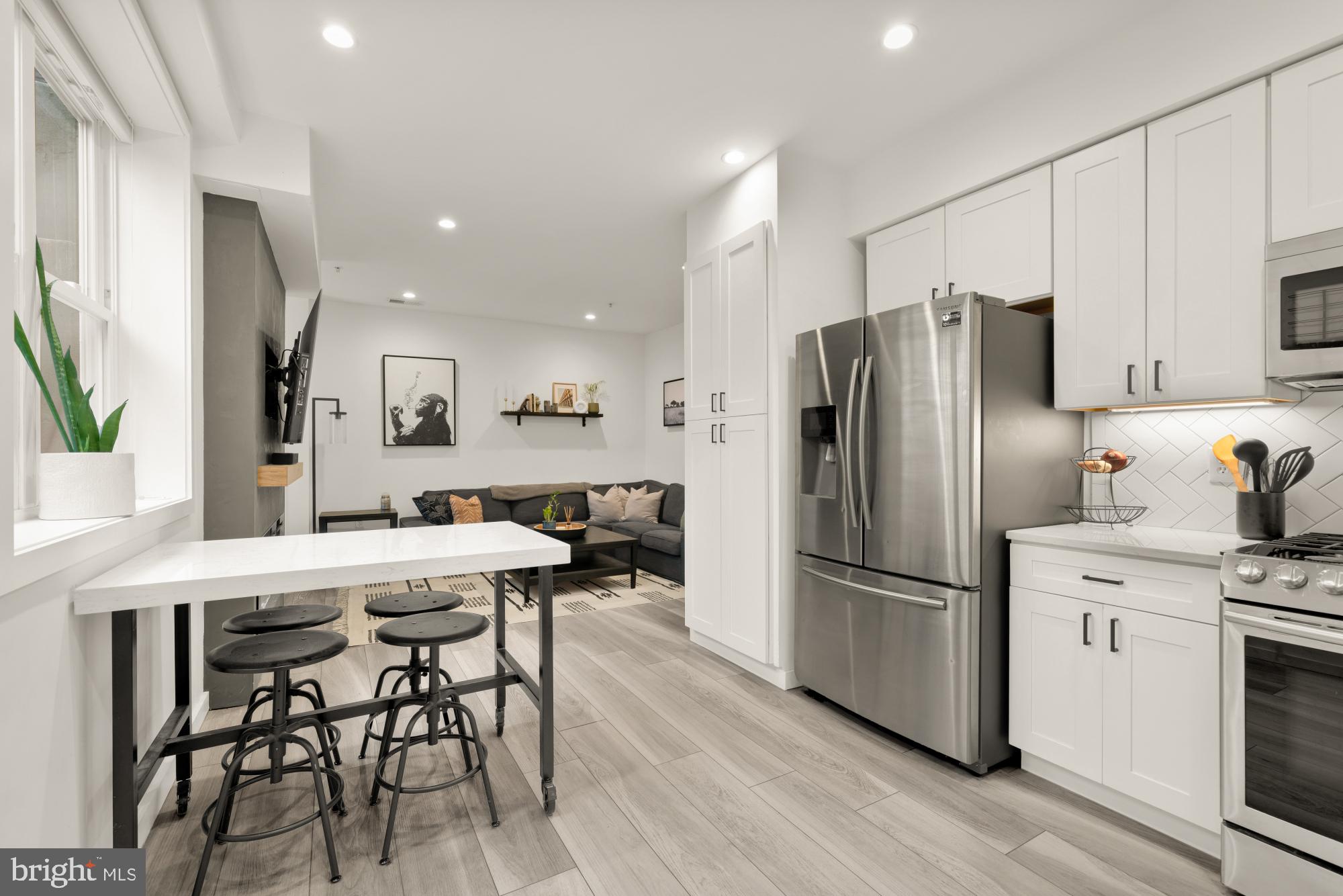 4816 3rd Street Northwest, Unit 2 Washington, DC 20011 - Photo 12 of 35 a kitchen with stainless steel appliances a refrigerator stove microwave and cabinets