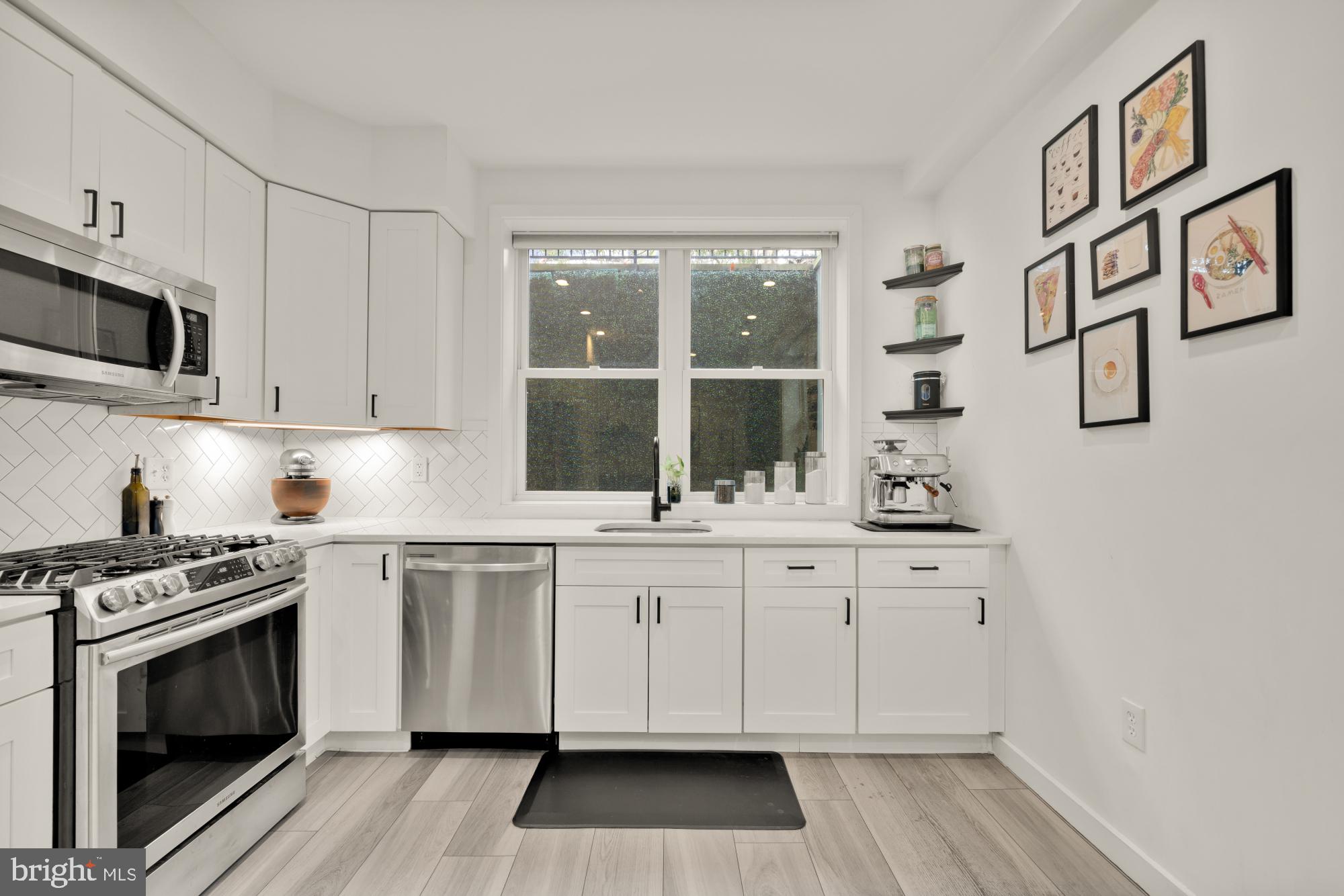 4816 3rd Street Northwest, Unit 2 Washington, DC 20011 - Photo 16 of 35 a kitchen with stainless steel appliances granite countertop a stove a sink and a microwave
