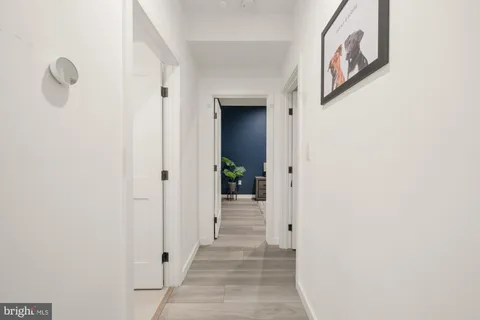 a view of a hallway to rooms and stairs