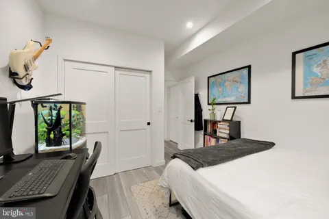 a bedroom with a bed a bookshelf and a desk
