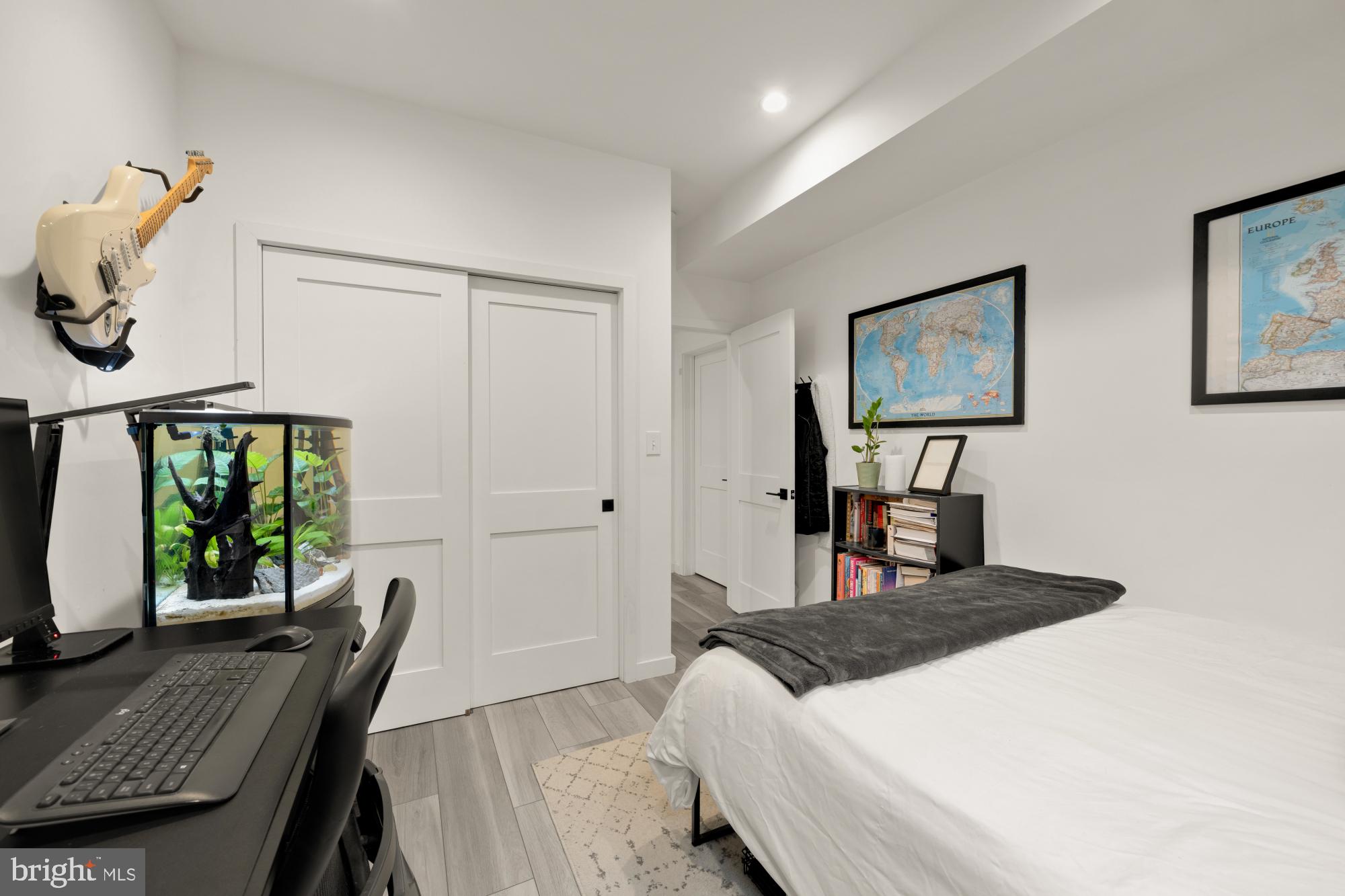 4816 3rd Street Northwest, Unit 2 Washington, DC 20011 - Photo 30 of 35 a bedroom with a bed a bookshelf and a desk