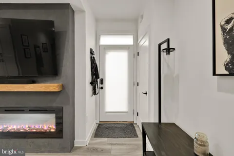 a view of a livingroom with wooden floor and a fireplace
