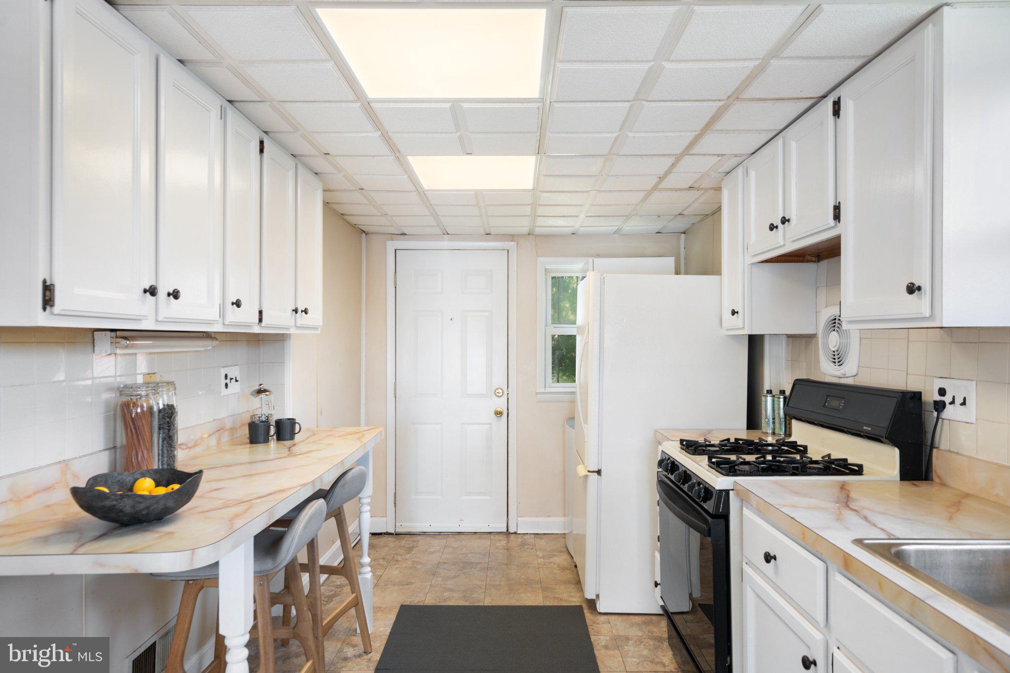 4618 Hilltop Terrace Southeast Washington, DC 20019 - Photo 11 of 36 a kitchen with stainless steel appliances a stove a sink and a refrigerator