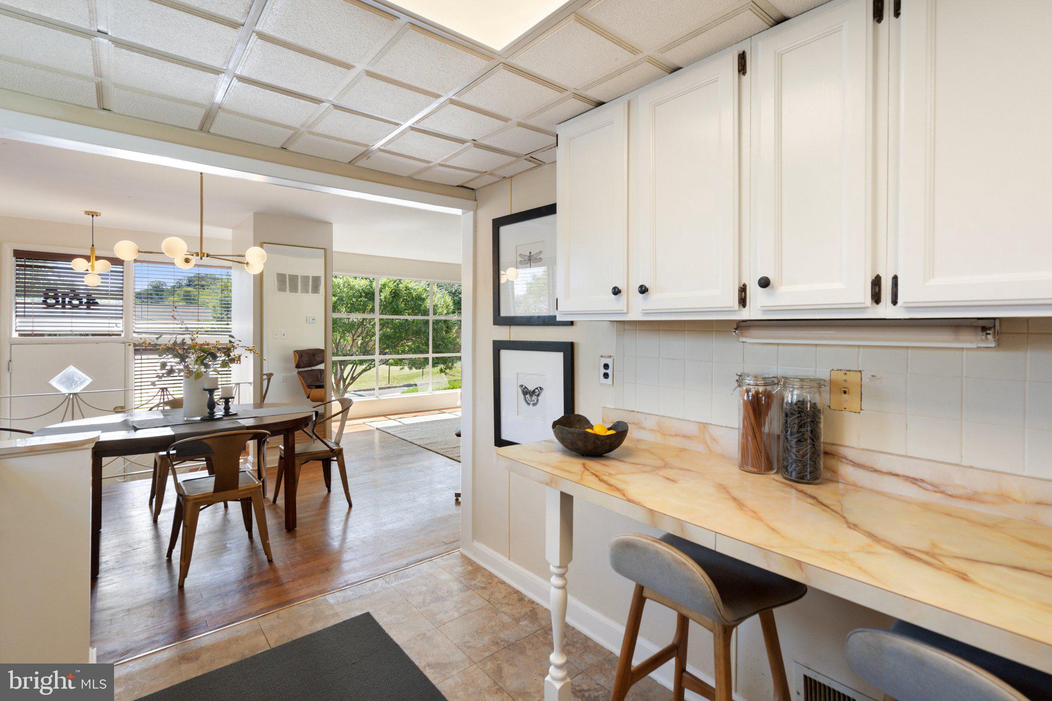 4618 Hilltop Terrace Southeast Washington, DC 20019 - Photo 13 of 36 a kitchen with a table chairs and a window