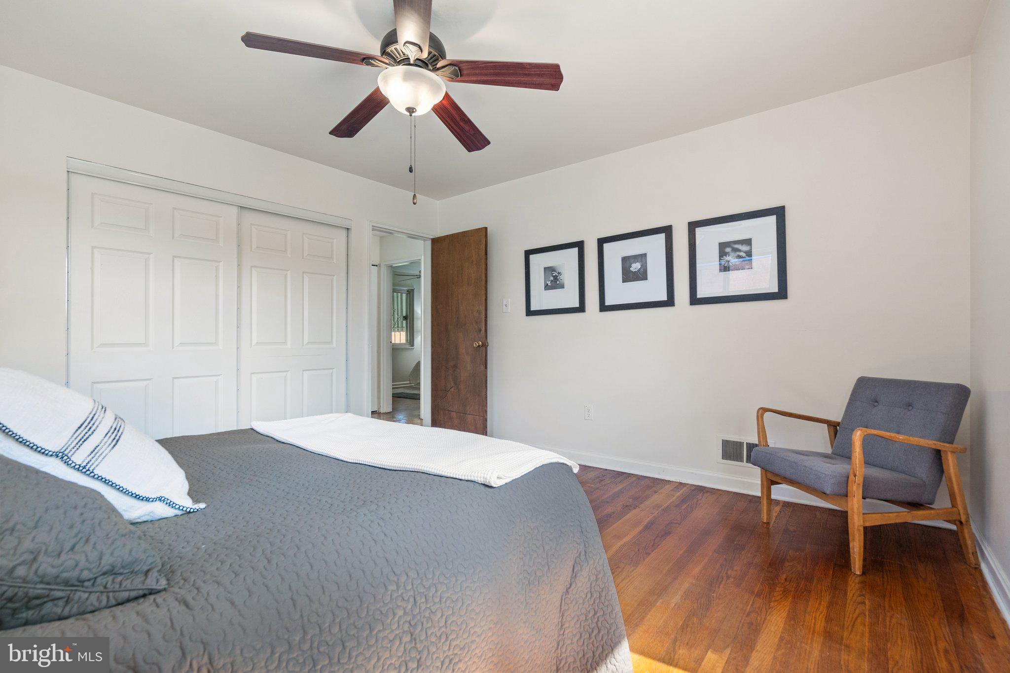 4618 Hilltop Terrace Southeast Washington, DC 20019 - Photo 15 of 36 a bedroom with a bed and a chair
